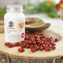 Dr. Harvey's Coenzyme Q10 supplement bottle with capsules on a wooden surface
